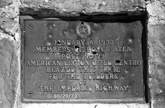 B/W photo: Bullet riddled plaque - Embedded text: 10/29/72