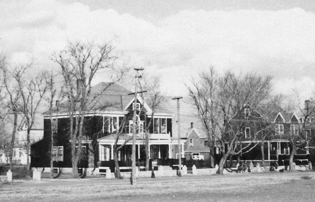 grayscale photograph: view of my home from accross street and empty lot