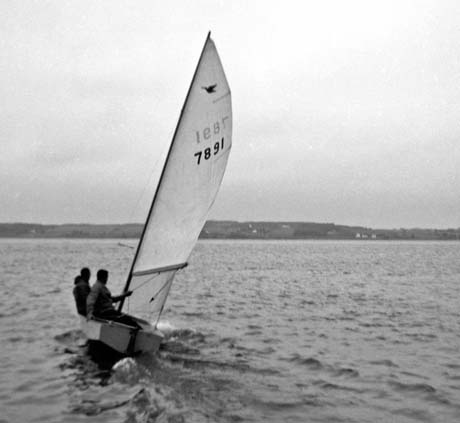 grayscale photograph: sailor controling sailboat