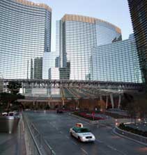 Color photo: Image of taxi on Harmon Ave with Aria Hotel/Casino in background