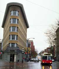 Color photo: Vancouver street scene with Flatiron style building on a triangular lot