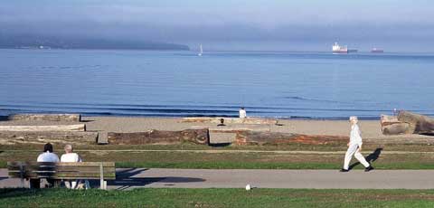 Color photo: Wide view of an early morning, Vancouver, beach scene