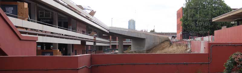 Red school buildings beyond solid red fence