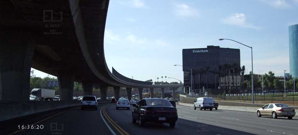 I5 south traffic on left visible through pillars supporting another freeway overhead