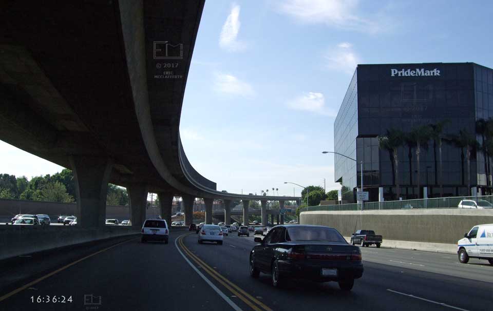 As above sweeping curve continues with large, black 'PrideMark' building on right