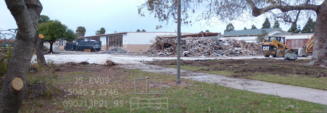 View of bare slab and rubble of now demolished West City building