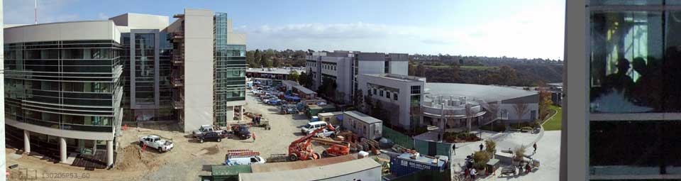 2 image pane > 1: High, wide view of Mesa College, new Science Building on left  2: Cropped from #1, workers viewing blueprints on 4th floor of Science Building