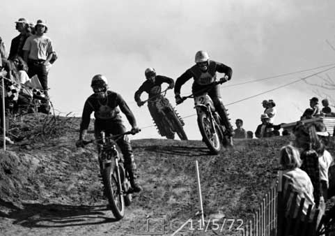 B/W photo of 3 racers cresting hill and a few spectators - Embedded text: 11/5/72