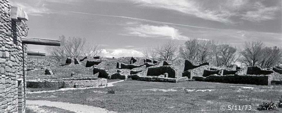 B/W photo: View of ruins/central plaza while walking adjacent to Great Kiva - Embedded text: 5/11/73