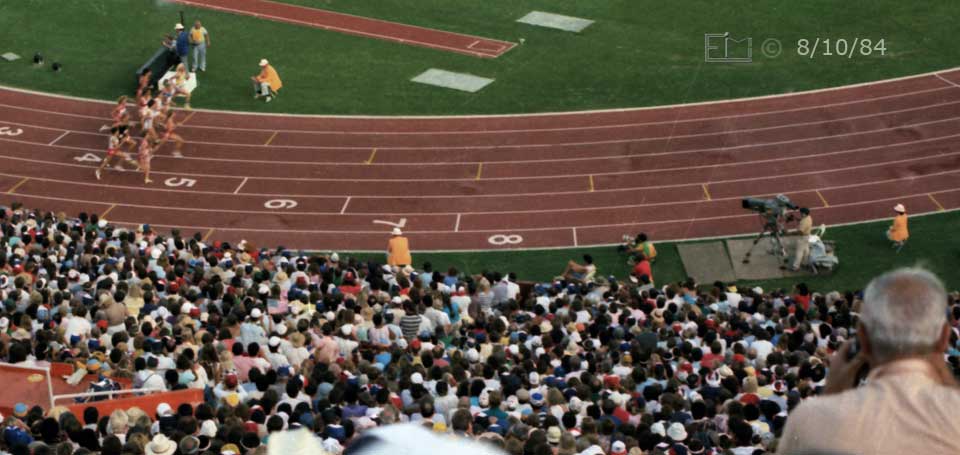 Color photo: Contestants underway at start of 3000 meter race - Embedded text: 8/10/84