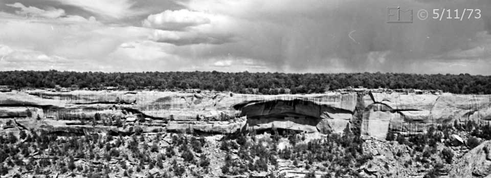 B/W photo: Wide angle view of Mesa Verde terrain/environment, including two tiers of cliff dwelling - Embedded text: 5/11/73