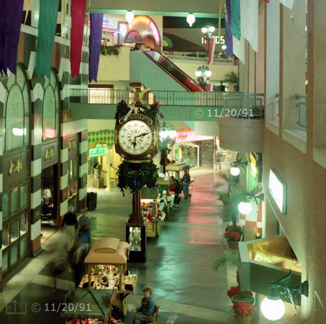 Color photo: Elevated view of shops and kiosks of Horton Plaza's lower level - Embedded text: 11/20/91