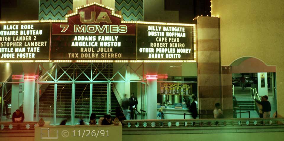 Color photo: Marquee, enterance and ticket window of multiplex movie theater - Embedded text: 11/26/91