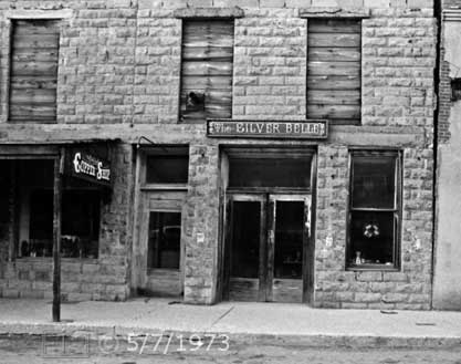 B/W photo: Front view of copper and silver ornament shop storefronts - Embedded text: 5/7/1973