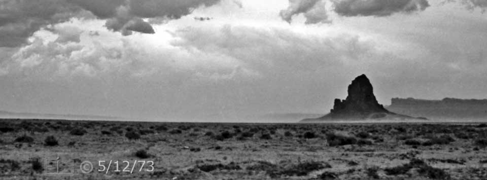 B/W photo: Distant view of volcanic landform with desert in foreground - Embedded text: 5/10/73