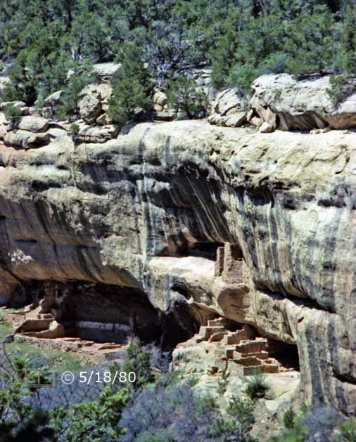 Color photo: Side portrait view of cliff dwelling ruins from across canyon - Embedded text: 5/18/80