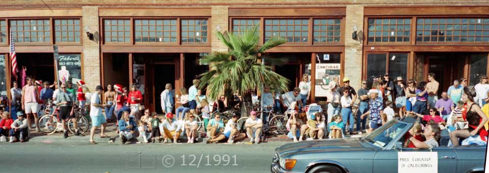 Color photo: Curbside spectators in front of Dunaway Building view passing automobile - Embedded text: 12/1991