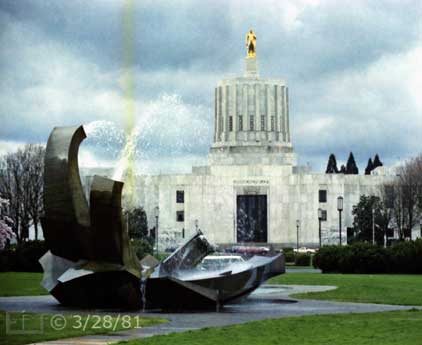 Color photo: Full view of water fountain with Capital building as backdrop - Embedded text: 3/28/81