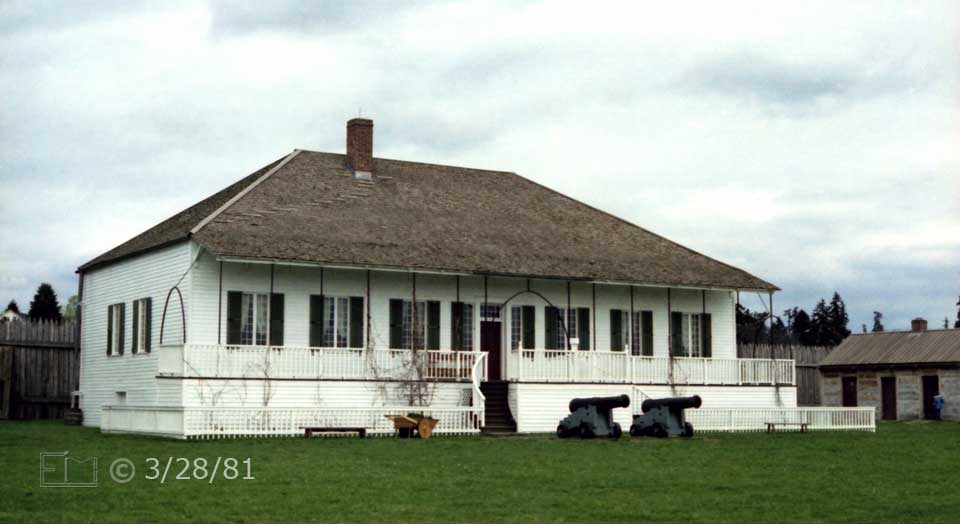Color photo: Main building, 2 conon in front, and utility buildings to right - Embedded text: 3/28/81