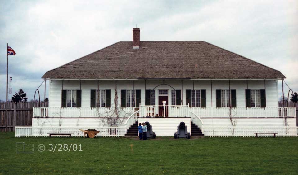 Color photo: Frontal view of main building with dual staircase to veranda and entrance - Embedded text: 3/28/81