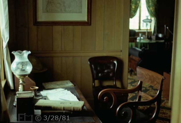 Color photo: Desk by window covered with papers and ledgers - Embedded text: 3/28/81