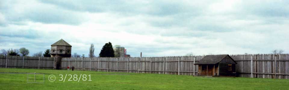 Color photo: Waatch tower and palisade surounding fort - Embedded text: 3/28/81