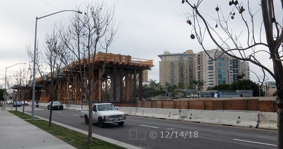 Color photo: Sidewalk view of 2 lanes of North bound traffic on Genesee Ave - Embedded text: 12/14/18