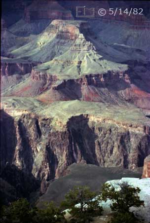 Color photo: Portrait view of Cheops Pyramid with trees, plateau and canyon wall in foreground - Embedded text: 5/15/82