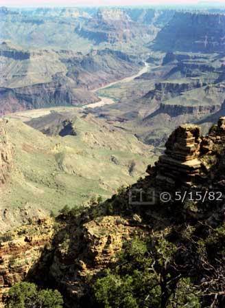 Color photo: Portrait view of Colorado River and its Grand Canyon surroundings - Embedded text: 5/15/82