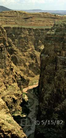 Color photo: View of Colorado River at the bottom of its surrounding gorge - Embedded text: 5/15/82