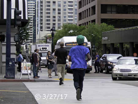 Color photo: Pedestrians in crosswalk traversing Broadway - Embedded text: 3/27/17