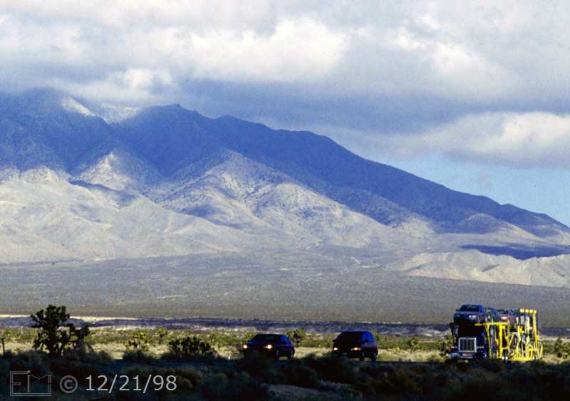 Color photo: Image taken on I15 freeway to Las Vegas of oncoming traffic and environment - Embedded text: 12/21/98