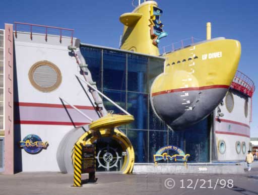 Color photo: Frontal view of a restaurant's unique architecture  - Embedded text: 12/21/98