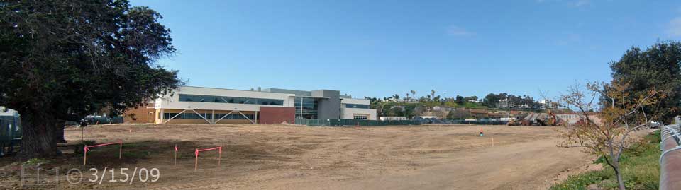 Color photo: View of cleared land and new West City Campus building from across alley; looking west - Embedded text: 3/15/09