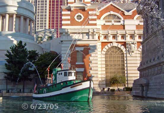 DSC color photo: Tugboat on water in front of NYNY - Embedded text: 6/23/05