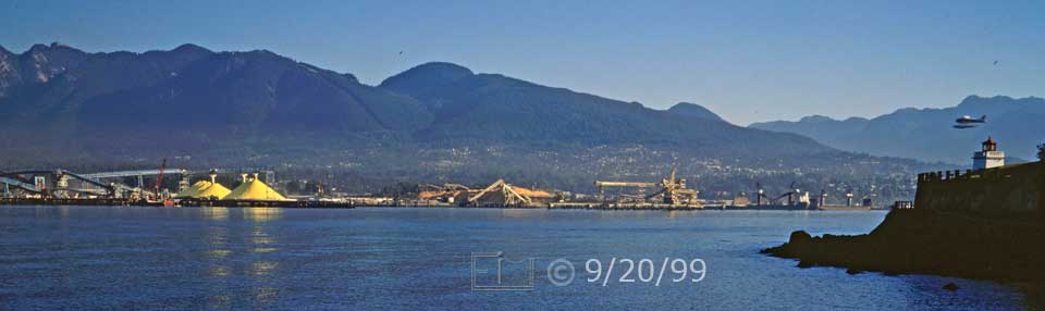 Color photo: Seaplane coming into land past a Stanley Park lighthouse - Embedded text: 9/20/99
