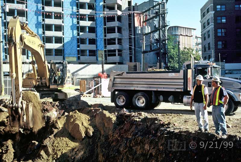 Color photo: Workers at a construction site - Embedded text: 9/21/99