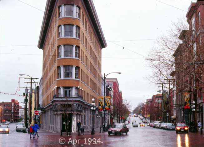 Color photo: Wide, across the street view of 'Flatiron' style building - Image taken: 4/7~12/1994