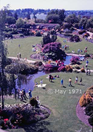Color photo: Elevated view of greenery, flowers and audience at Queen Elizabeth Park - Embedded text: May 1971