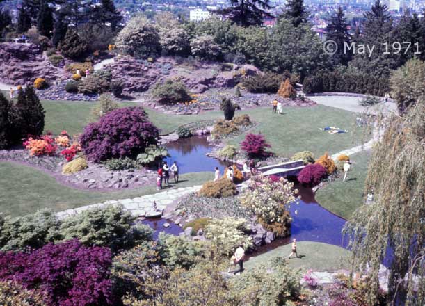 Color photo: Elevated view of greenery, flowers and audience at Queen Elizabeth Park - Embedded text: May 1971