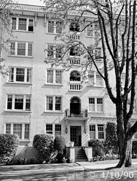B/W photo: A tree of many vertical branches in front of a vintage apartment building - Embedded text: 4/10/90