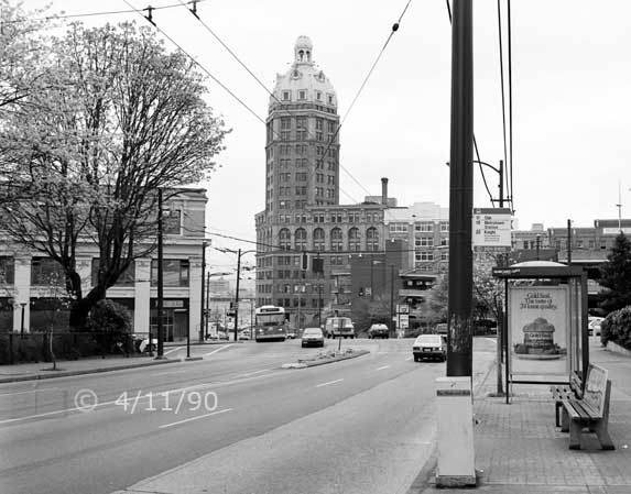 B/W photo: A West Pender St. scene with Sun Tower in distance on the other side of Cambie St. - Embedded text: 4/11/90