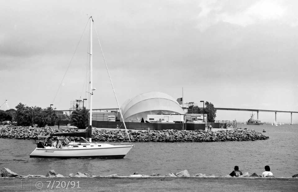 B/W photo: Sightseers view boat in marina outlet to San Diego Bay - Embedded text: 7/20/91