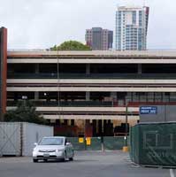Color photo: East view of hollowed out "T" building