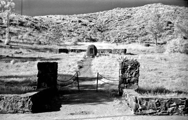 Infrared B/W image: View of masonry entrance, monument and grounds.