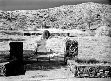 Infrared B/W image: View of masonry entrance, monument and grounds.